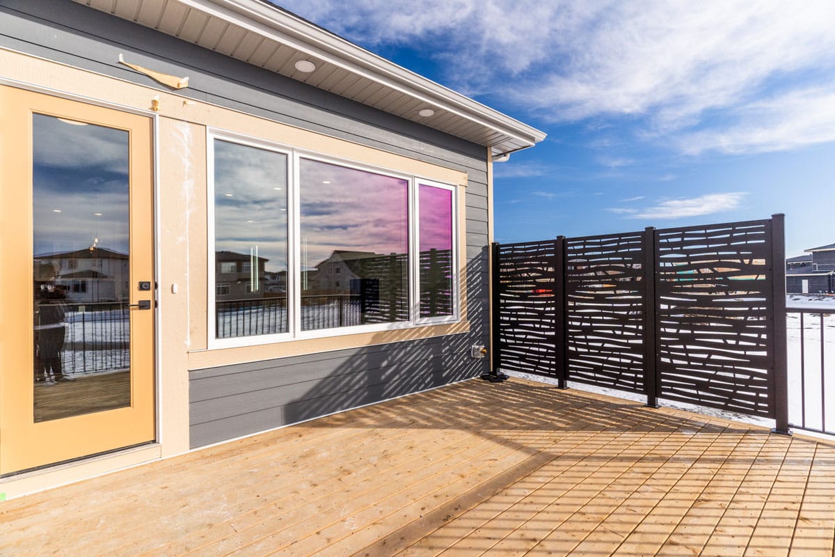 Back deck with privacy screen on a Golden Homes house in Kinniburgh South
