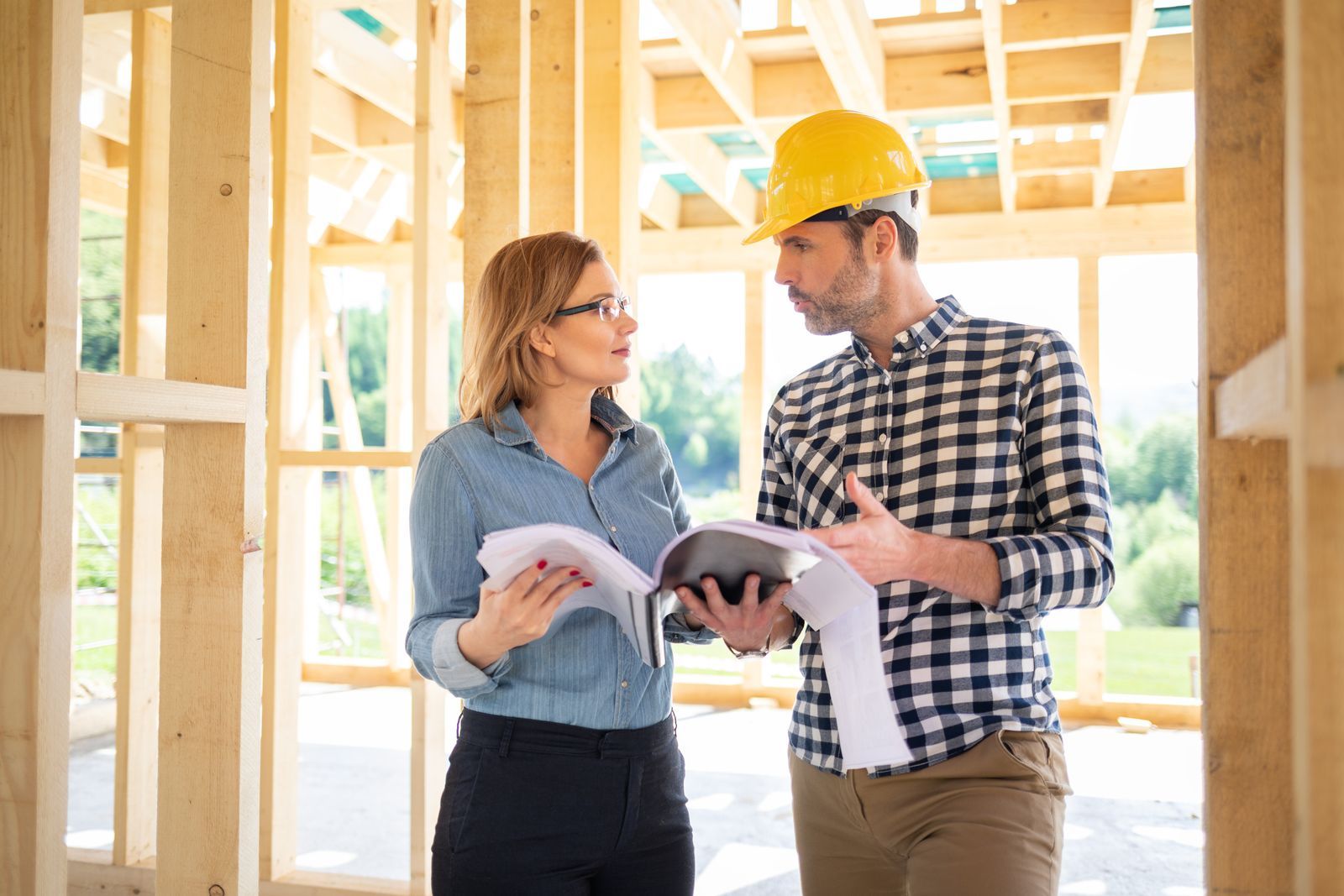 construction-workers-discussing-plans-on-building-2026-03-10-22-23-41-utc.jpg